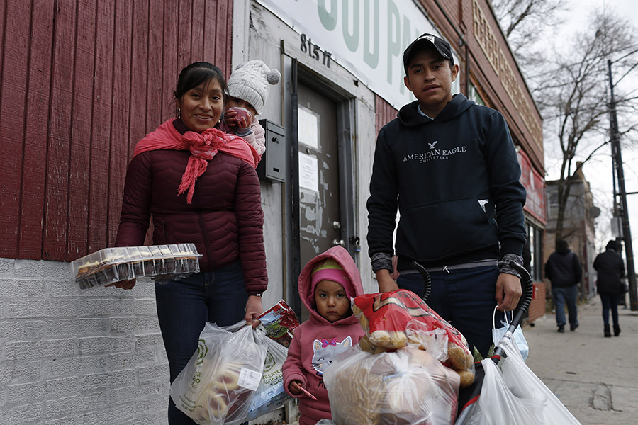 A family stands outside a food pantry