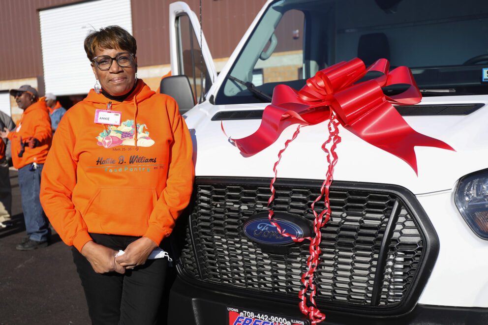 Annie Hill poses with a van lent to the Hattie B. pantry from the Food Depository.