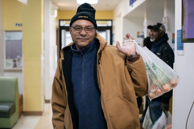 Community member receiving fresh food. 