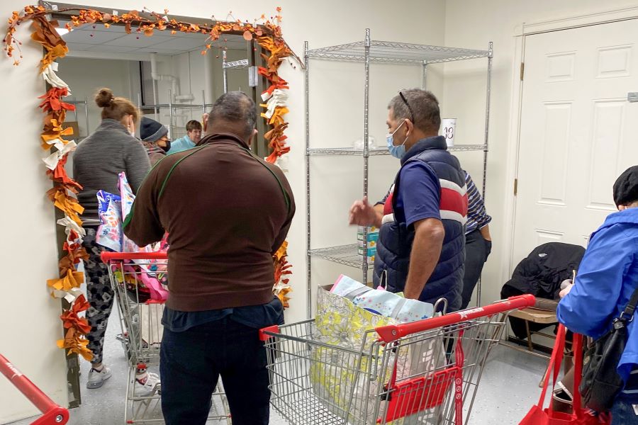 Guests wait in line to access the pantry.