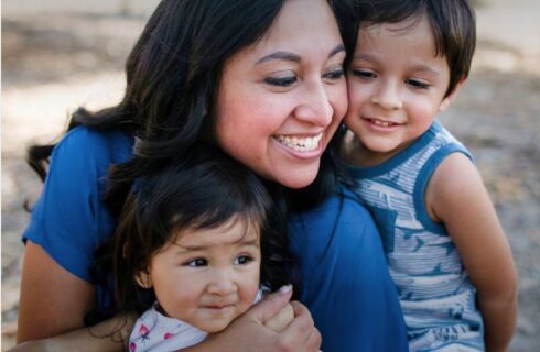 Mother smiling with two young children