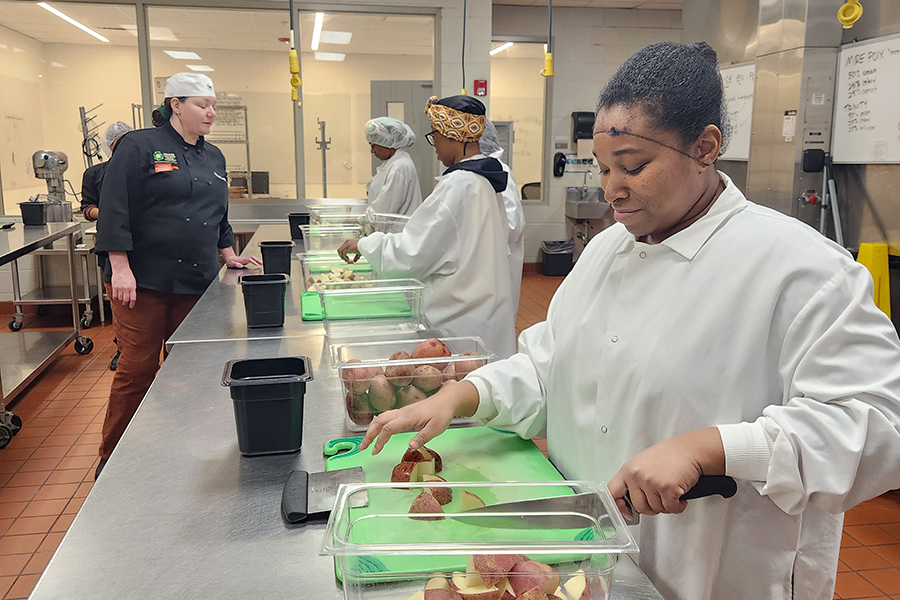 students learn knife skills
