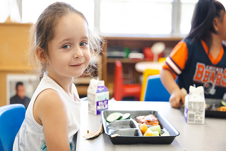 This child is eating a snack during a break in school provided by the Greater Chicago Food Depository.