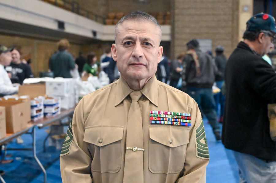 A man in uniform looks at the camera.