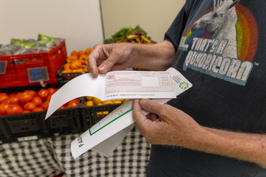 A man holds coupons.