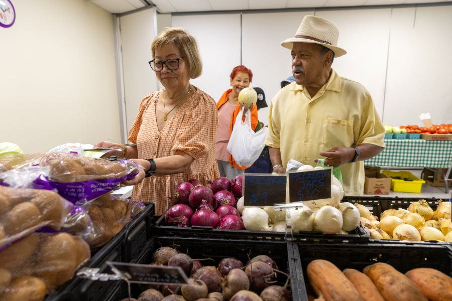 A man and woman shop for produce.