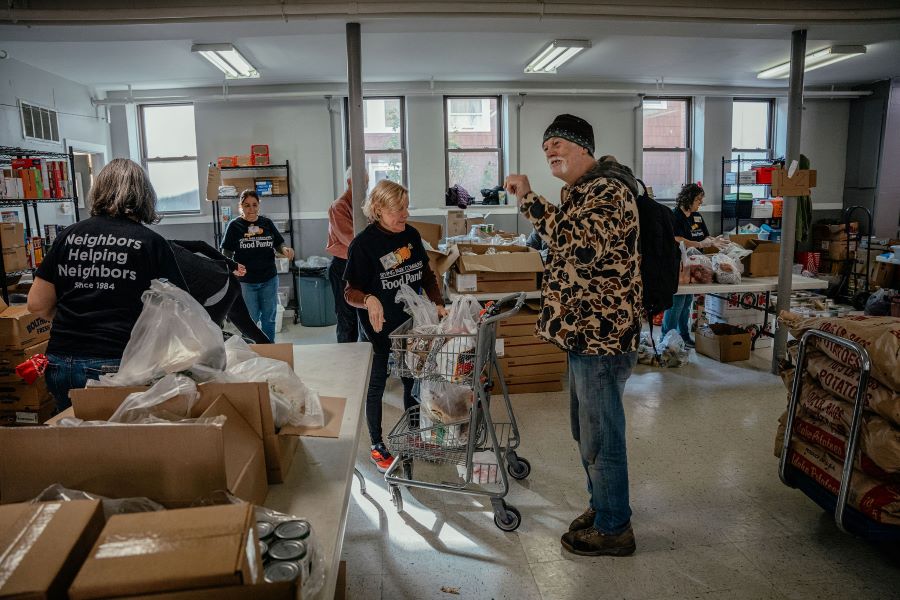 A man shops for groceries at a food pantry