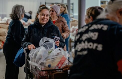 a woman shops for groceries at a food pantry