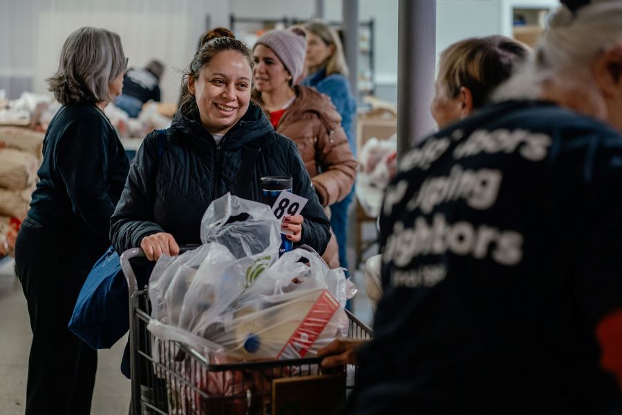 a woman shops for groceries at a food pantry