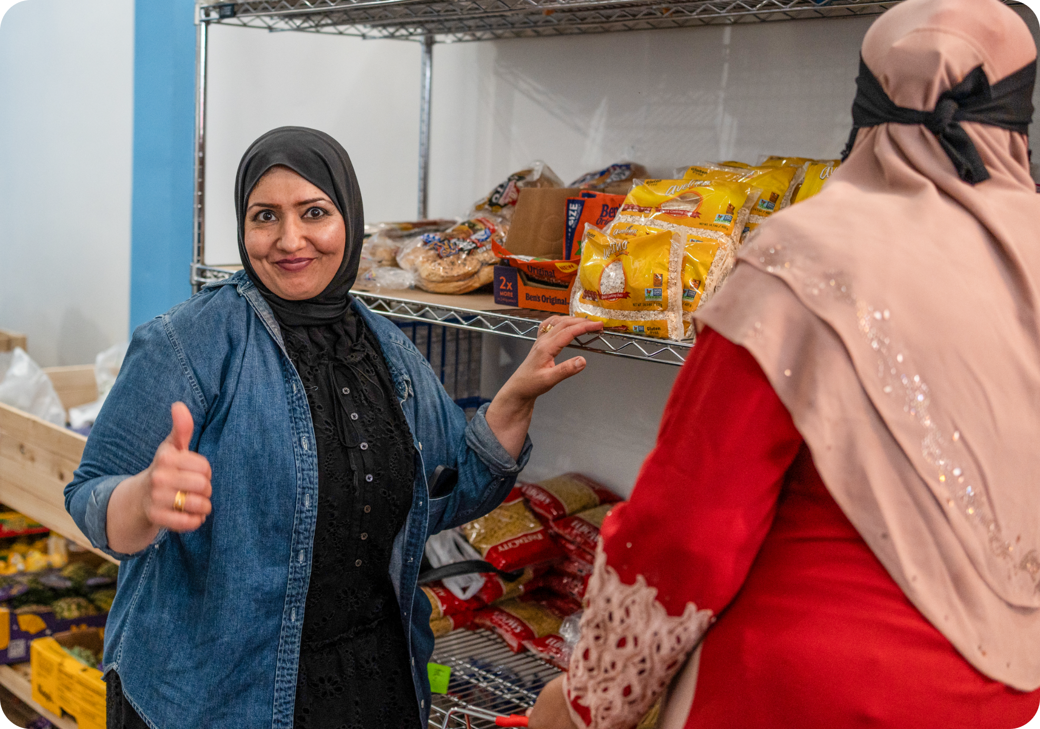 Agents of Hope Pantry volunteer Qismah is shown distributing food and interacting with a pantry guest.