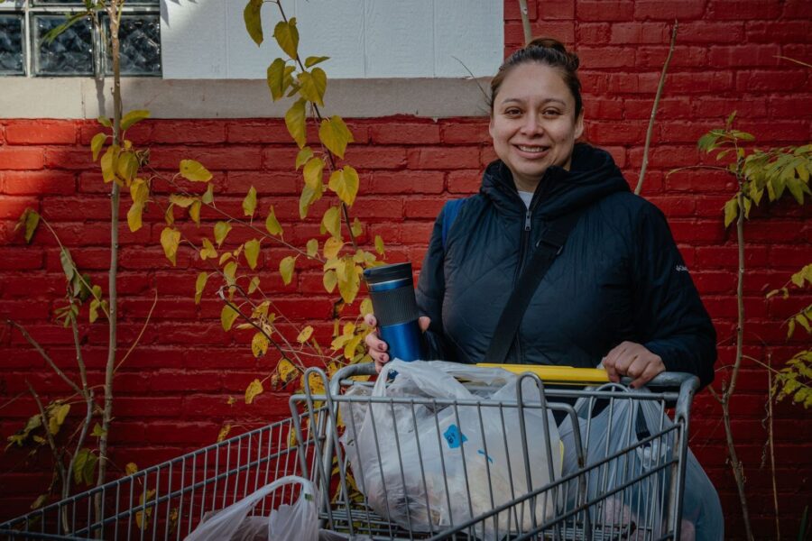 Woman with a loaded shopping cart