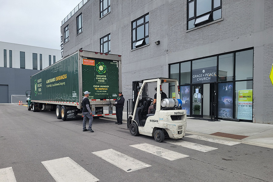 People unload a Food Depository truck