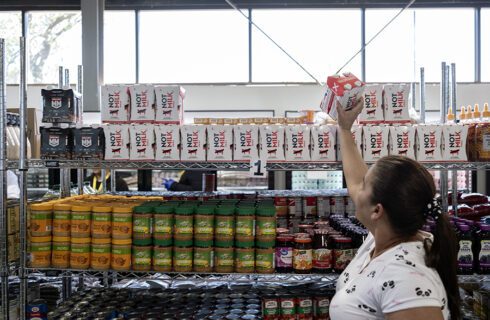 A woman chooses an item at a food pantry