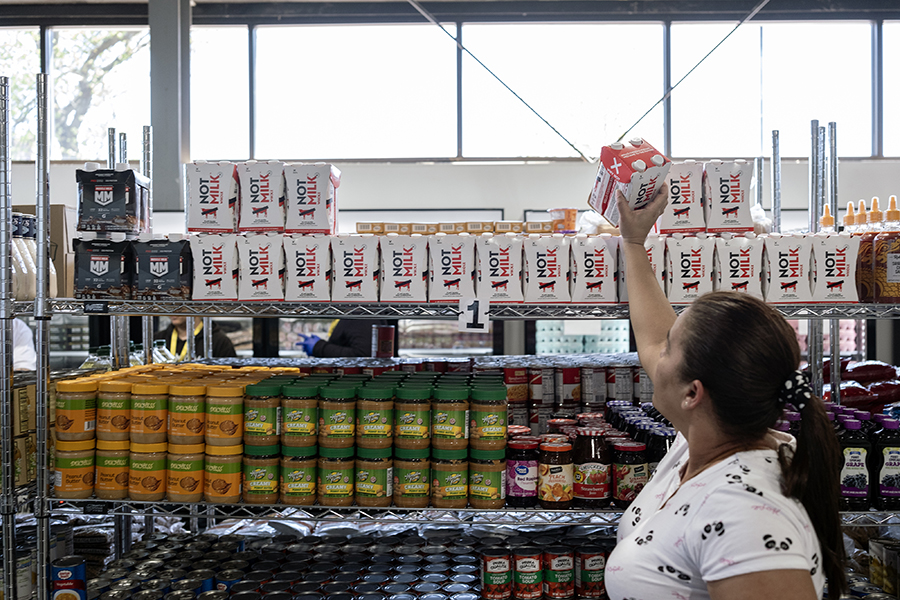 A woman chooses an item at a food pantry