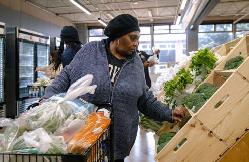 a woman shops for produce at a food pantry