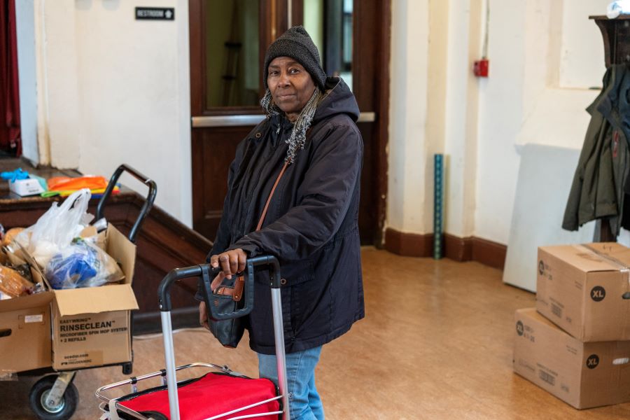 a food pantry guests looks at the camera