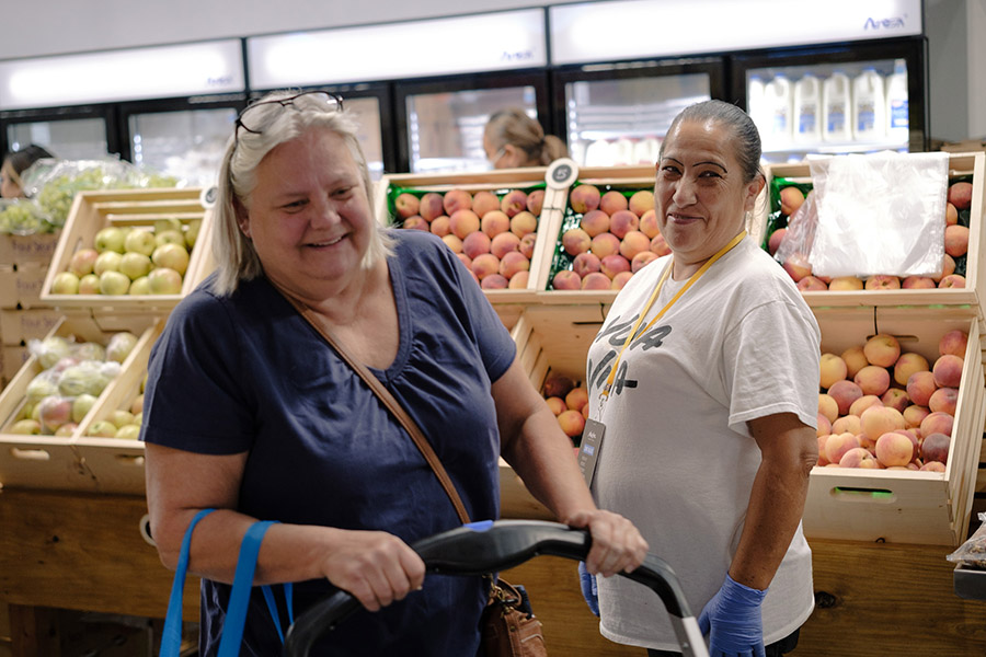 a woman shops for groceries at a food pantry