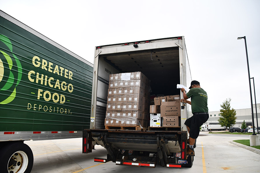 a driver loads a truck for delivery