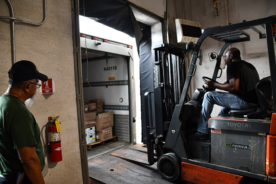 A Green Era driver unloads food at their facility