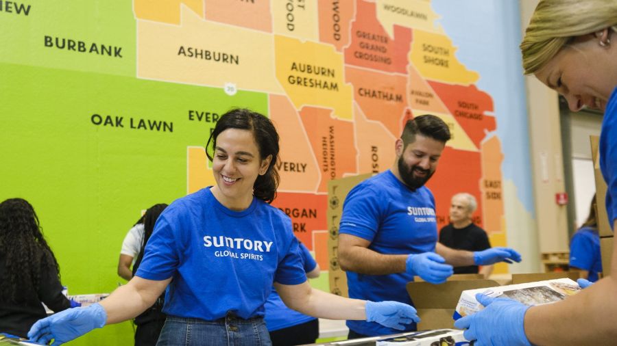 Volunteers wearing the same t-shirts pack food