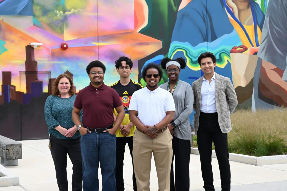 Group photo in front of a mural